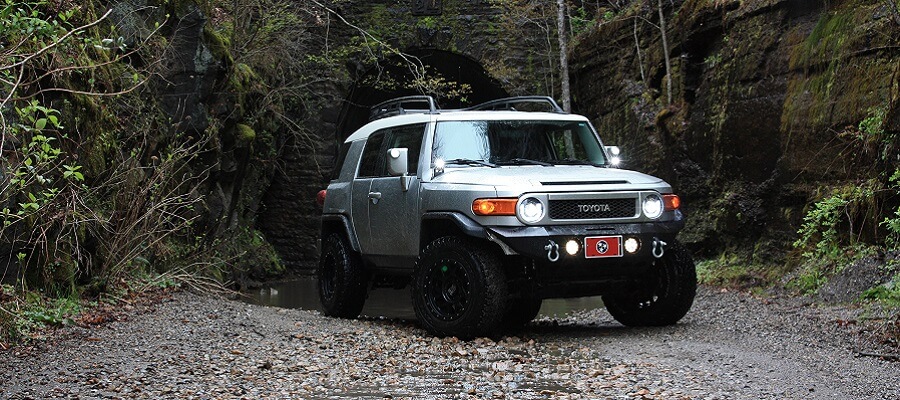 Toyota four wheel drive SUV on a dirt road in the jungle