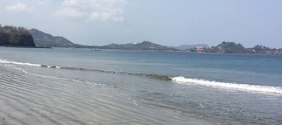 Small waves break on the sand at Playa Penca.