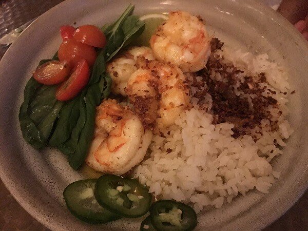 Tender and sweet garlic shrimp with sticky rice and greens.